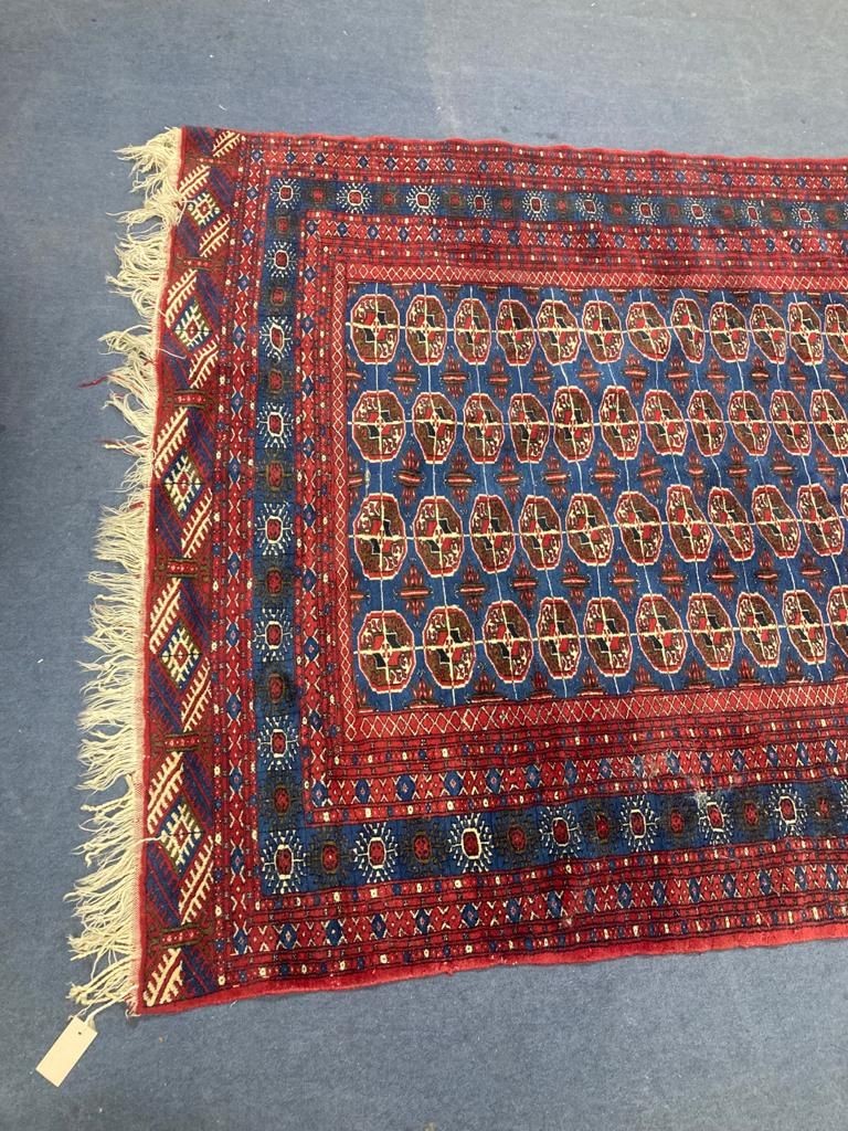 A Bokhara blue ground carpet. 240x150.